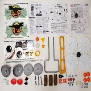 Hardware pack- Gas Cap. Screws. Bushing Wire Form. Washers. Steering Wheel O-Ring. Hubcaps. Top hat Tool. Wire form Left/Right. Retaining Clip. Fastener. Cap nut. Horn Button. Axle. Decals. Horn. Eye Fronts. Eye Backs Left & Right. Spike. Base Yellow